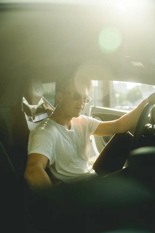 a man sits in a car on the phone