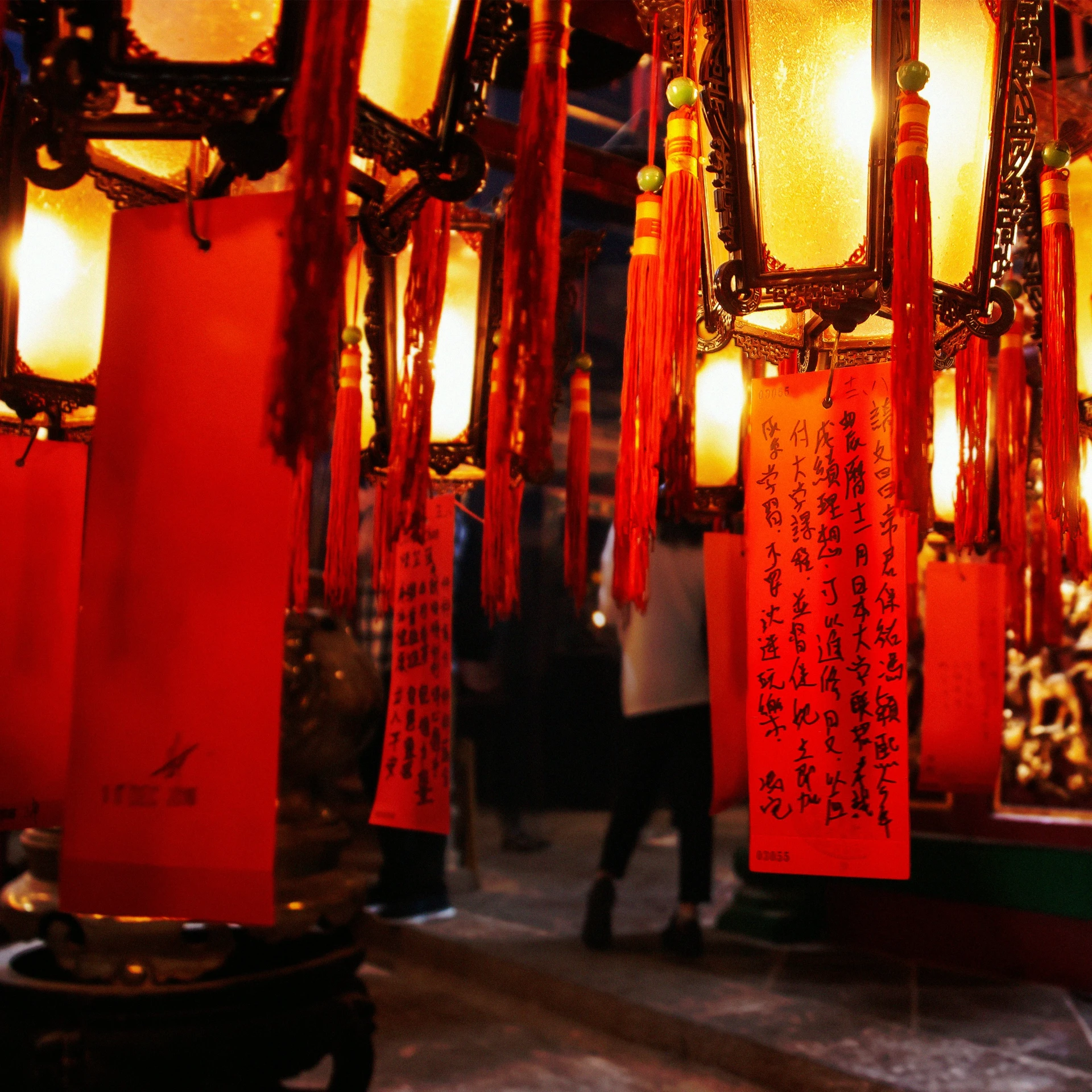 several lights hanging over a street at night