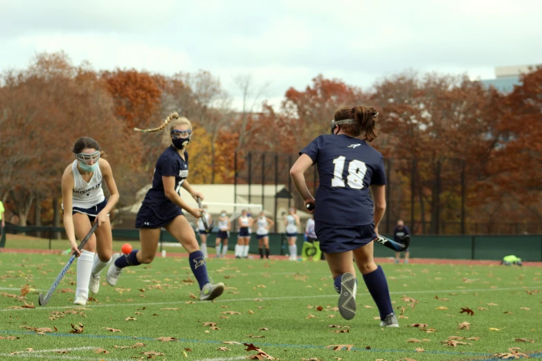 the girls are playing soccer on the field