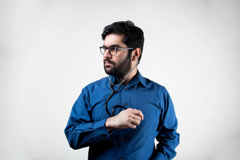 a man with eye glasses wearing a stethoscope