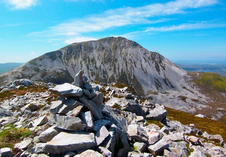 a pile of rocks on a very high mountain