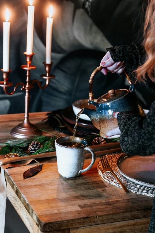 an elegant tea kettle pouring water into cups