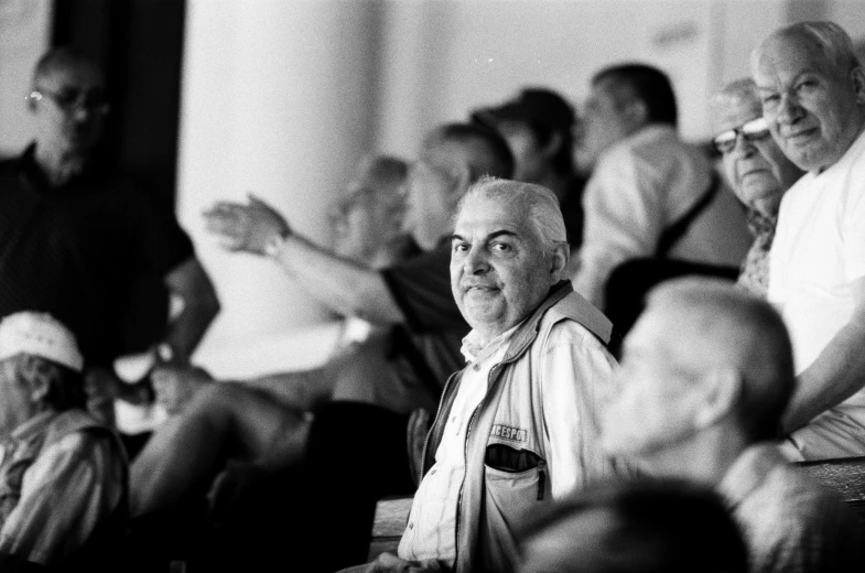 group of people sitting together and one woman standing