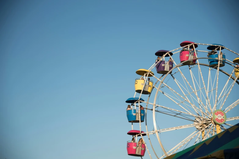 a ferris wheel at a fair with a blue sky in the background