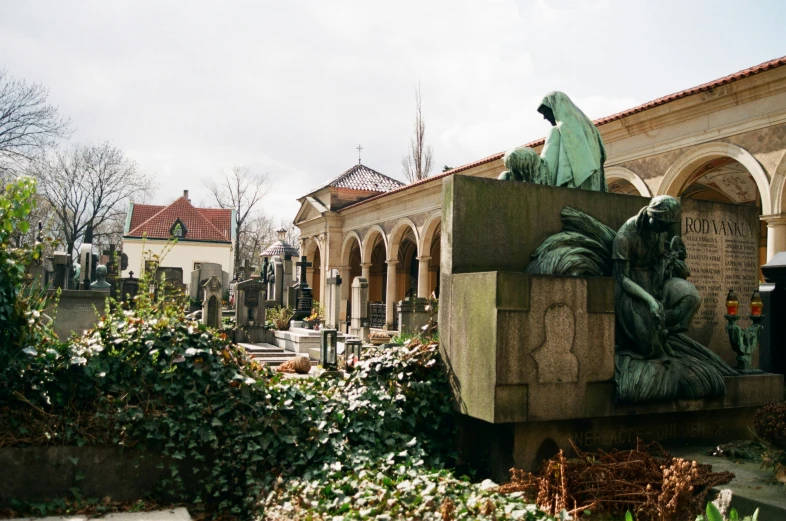 a fountain in a cemetery with a statue of a woman reading