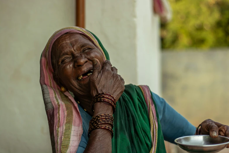 an older woman holding a bowl and smiling