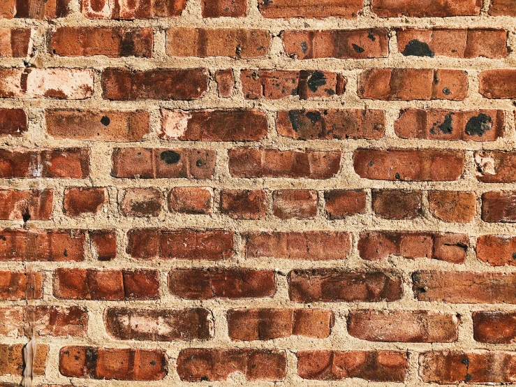 a brick wall made of various orange brick blocks