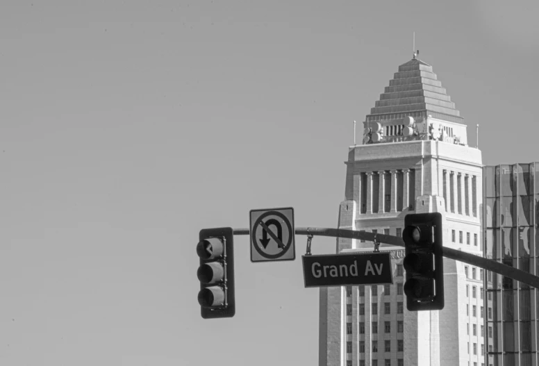 street signs are posted above a traffic light