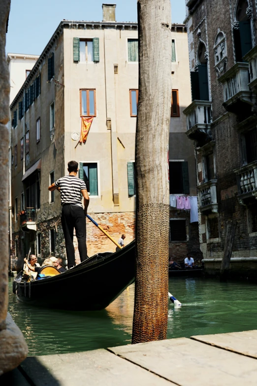 a small boat traveling down a canal surrounded by old buildings