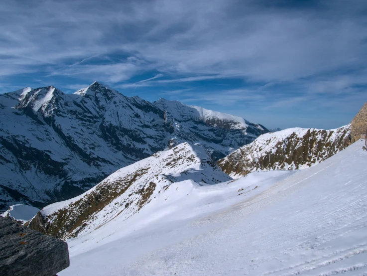 a man on skis riding up a mountain slope