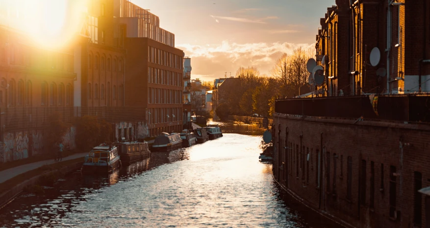 boats floating in the water next to old buildings