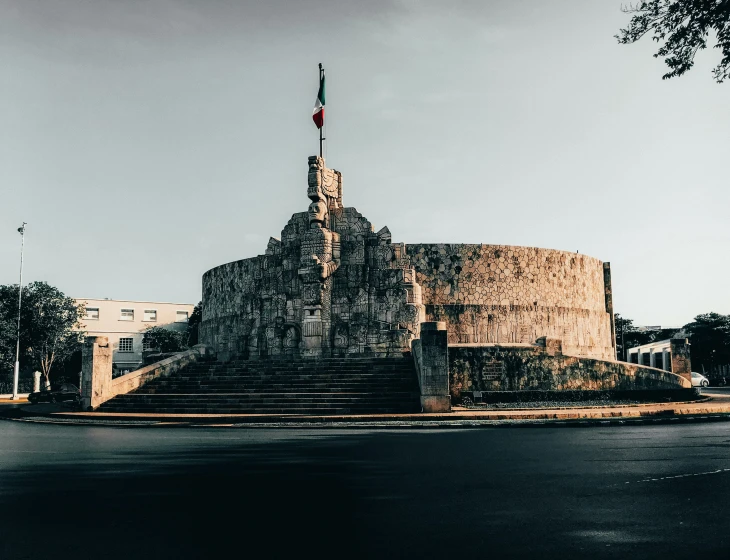 a very large brick structure with a flag on it