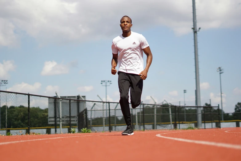 an african man running on a tennis court