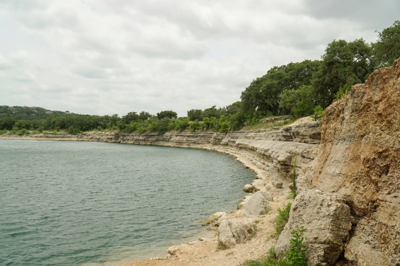 an expanse of water on a dirt shore