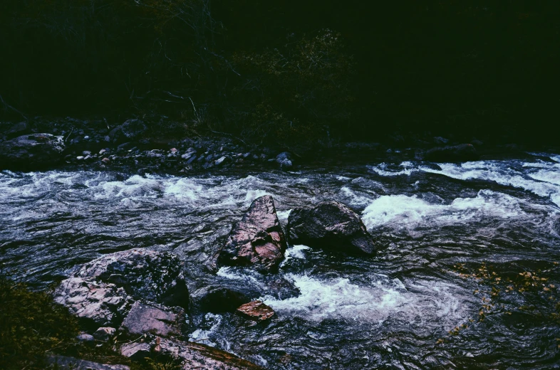 a bunch of water flowing over rocks