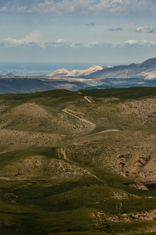 a road goes through the rocky hills by the ocean