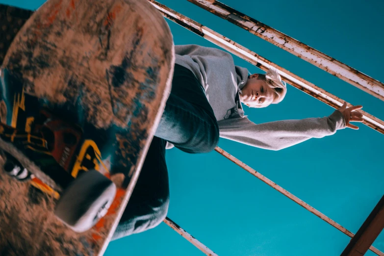 skateboarder preparing to go down a rail in the air