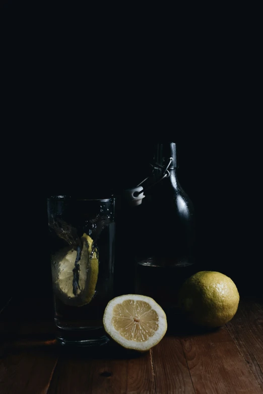 a couple of slices of lemons next to a glass