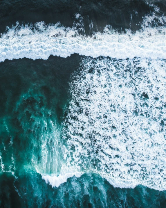 a view of some green ocean waves and the sky