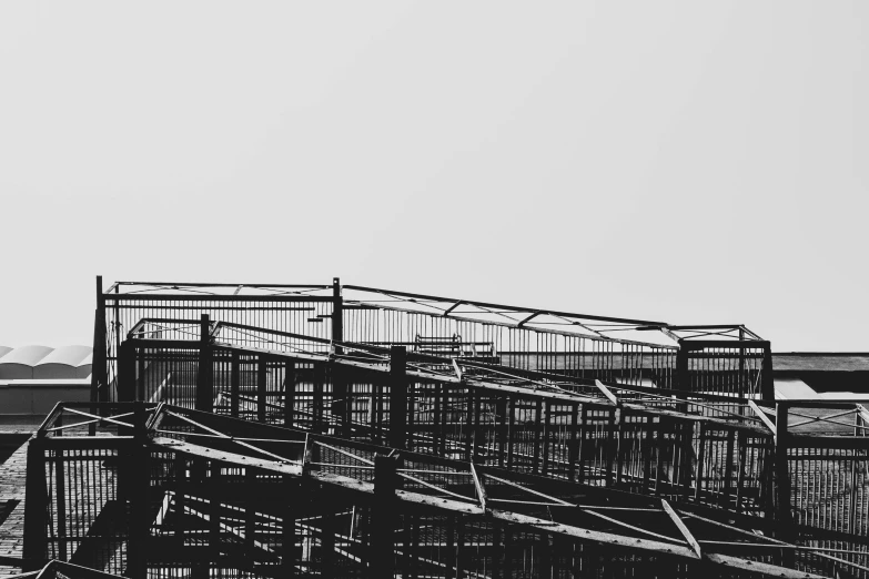 a group of birds are flying over some fence