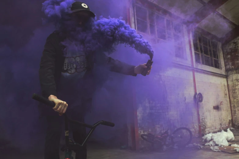 a person with purple smoke on a bike