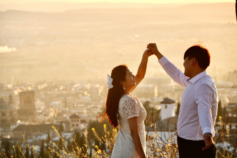 a young couple celeting on top of a mountain