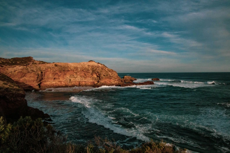 a body of water near a rocky shore