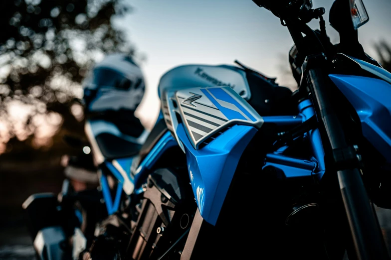 a blue motorcycle parked in the sun during the day