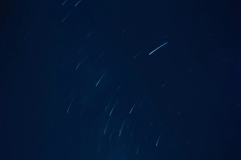 stars and shooting stars above the earth at night