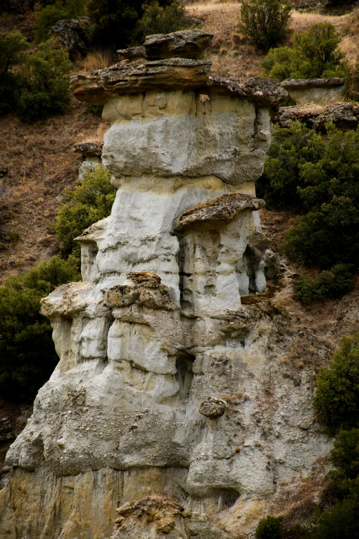 a couple of small rock formations on the side of a hill