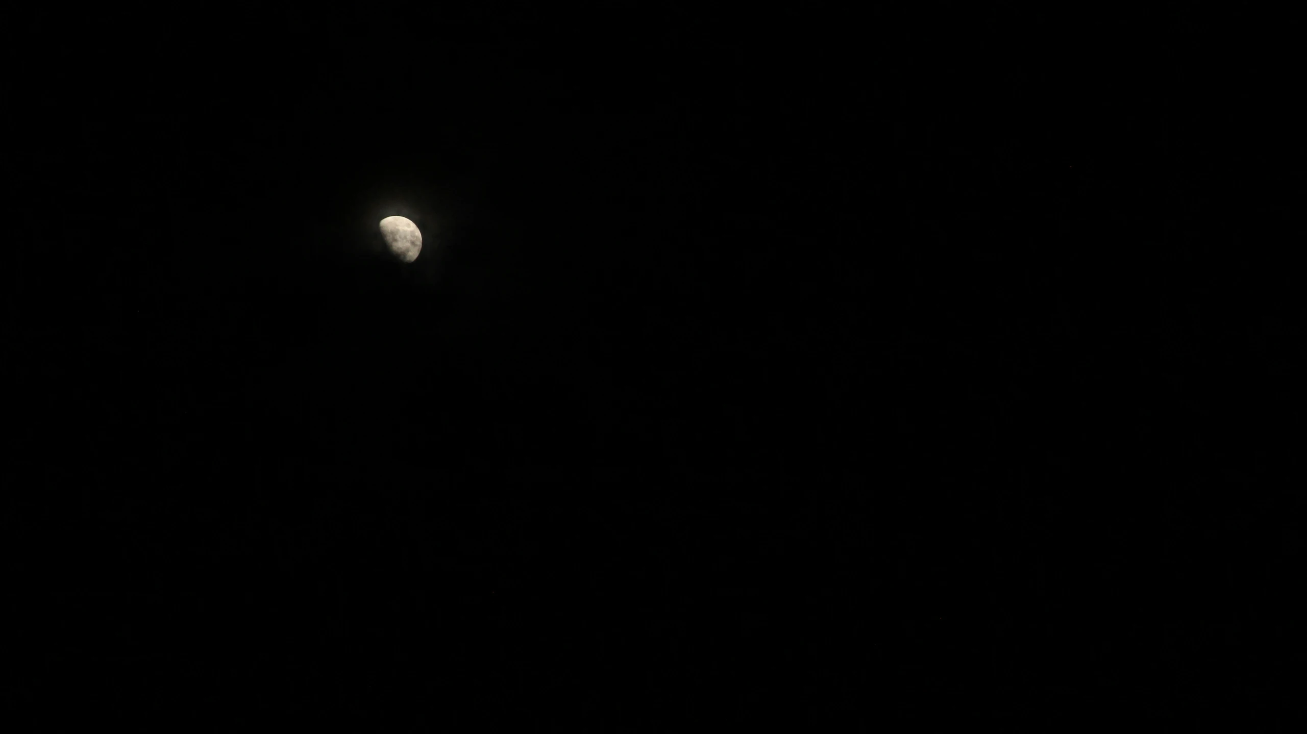 a view of the moon at night time