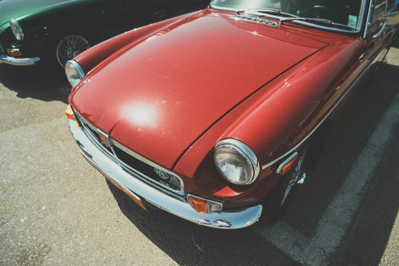 two vintage cars in the parking lot near each other