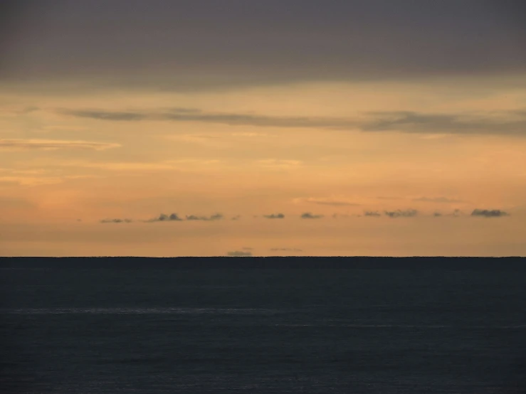 an image of ocean with ships on horizon