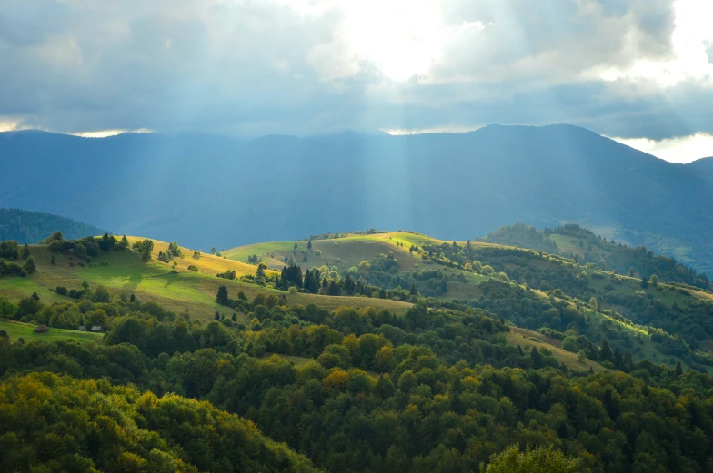 there is an image of mountains with sun beams