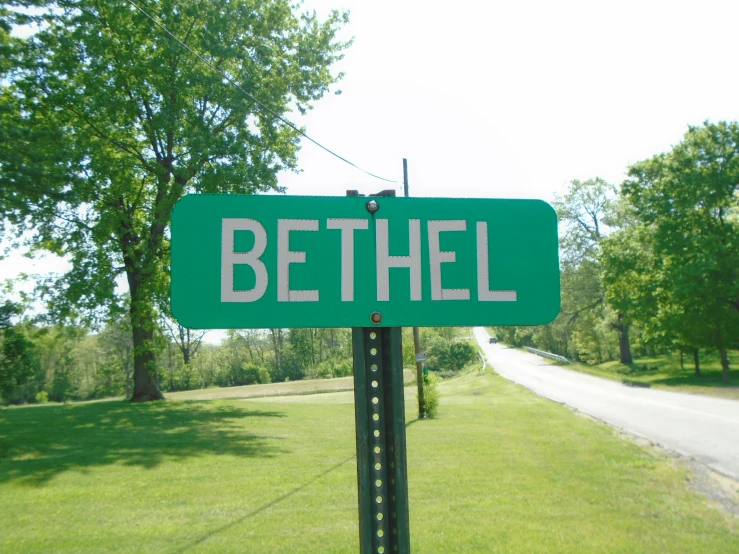 a street sign for bethel at the edge of the road
