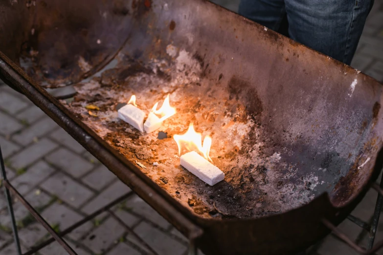 three candles lit on an open steel plate