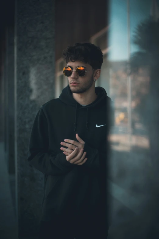 a person is standing outside and wearing some sunglasses