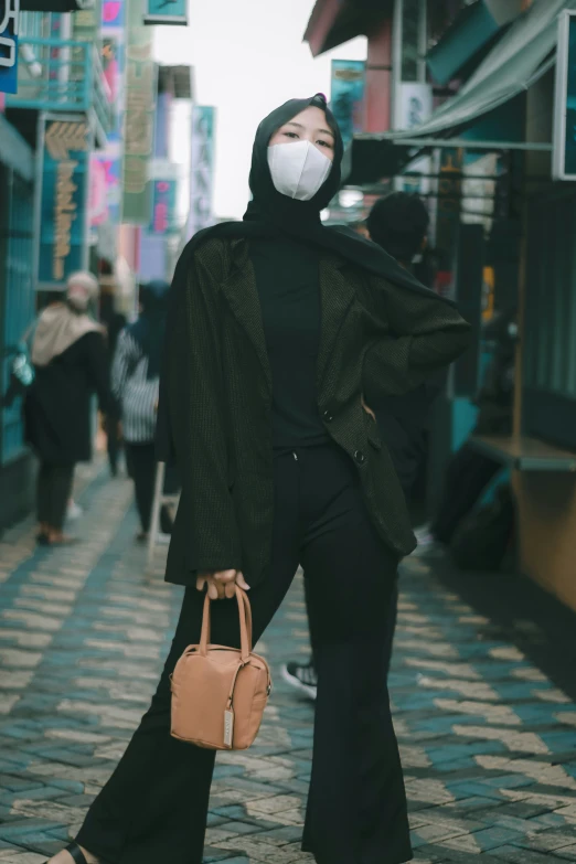 a woman wearing a mask with a handbag