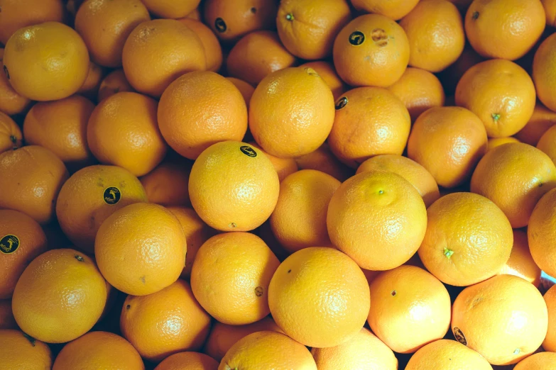 a bunch of oranges that are sitting together