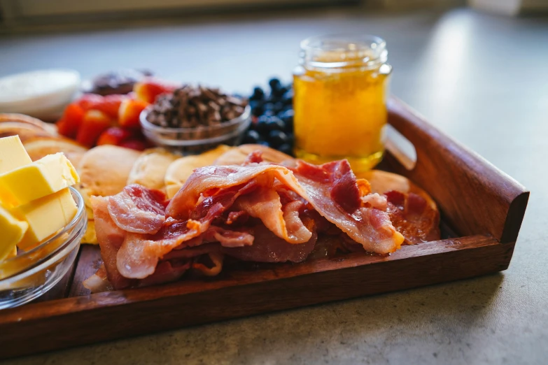 the food is ready to be eaten on the wooden tray