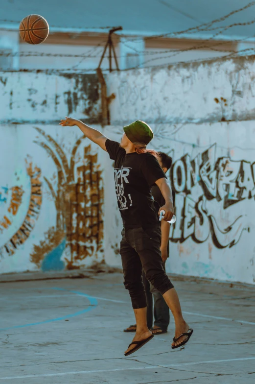 a man jumping up to grab a basketball in the air