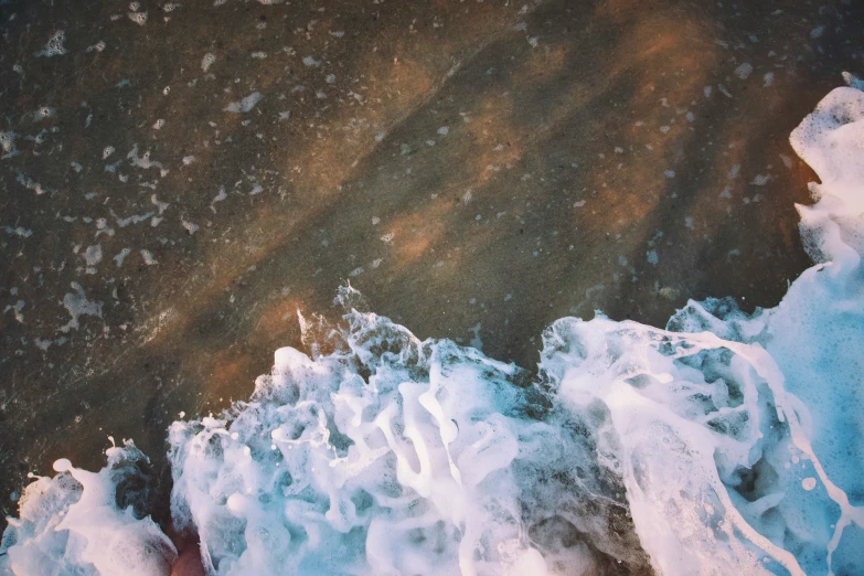 the top view of some white waves in water