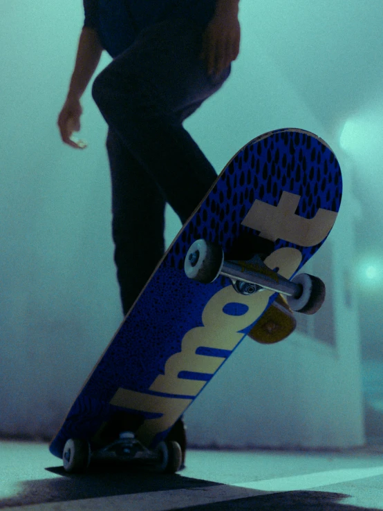 a person wearing black pants with their foot on a skateboard