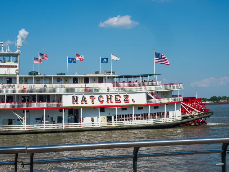 the boat is painted with flags and red on it