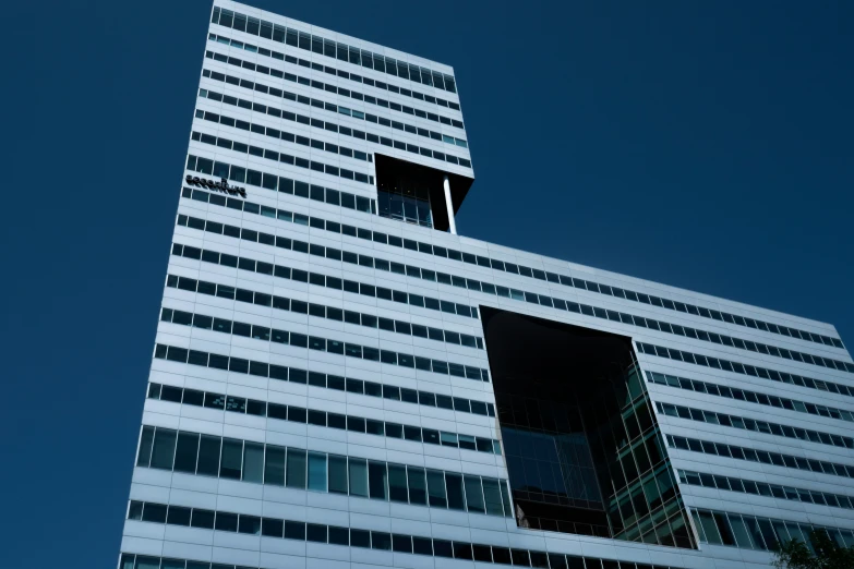 a tall building with a plane flying in the sky