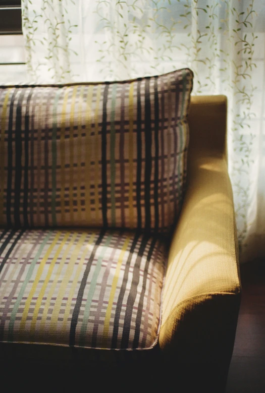 a sofa in front of a window and curtains