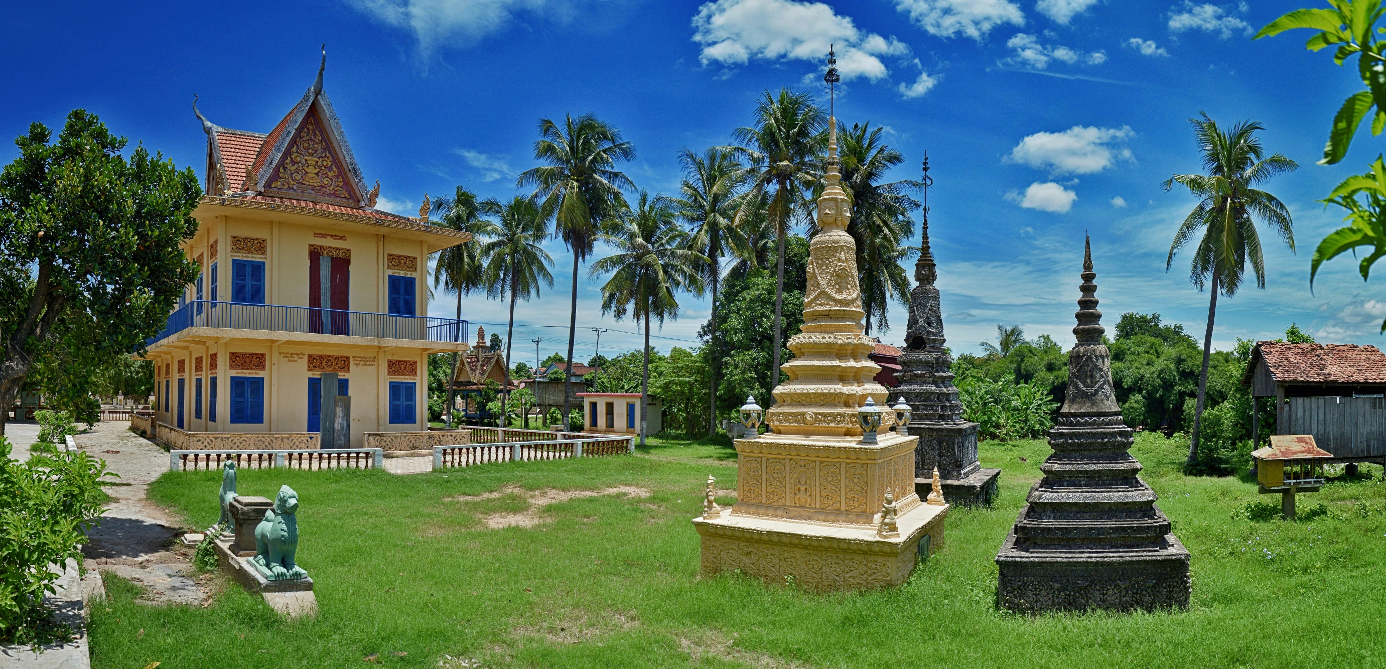 a park in front of a house with many statues