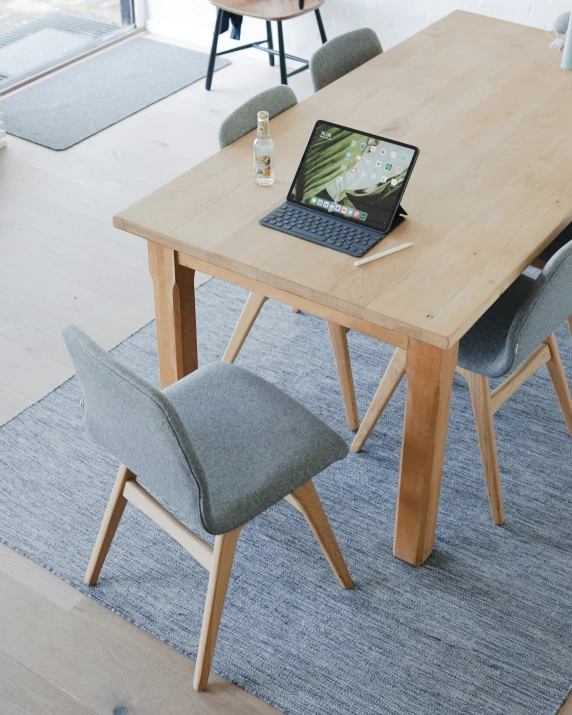 a computer is placed on top of the wooden table