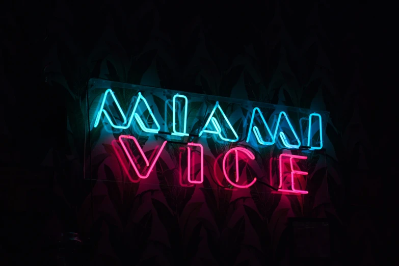 a neon sign on the wall says, miami vice