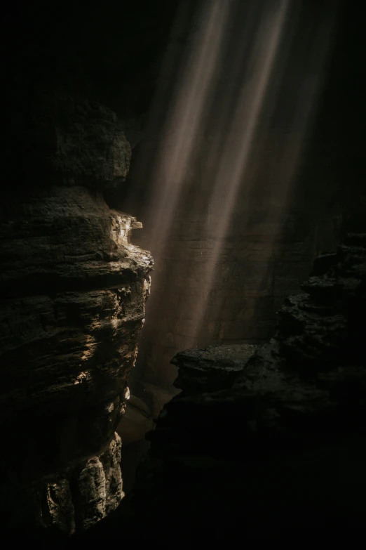 the sunlight shines through the rocks at a rock face